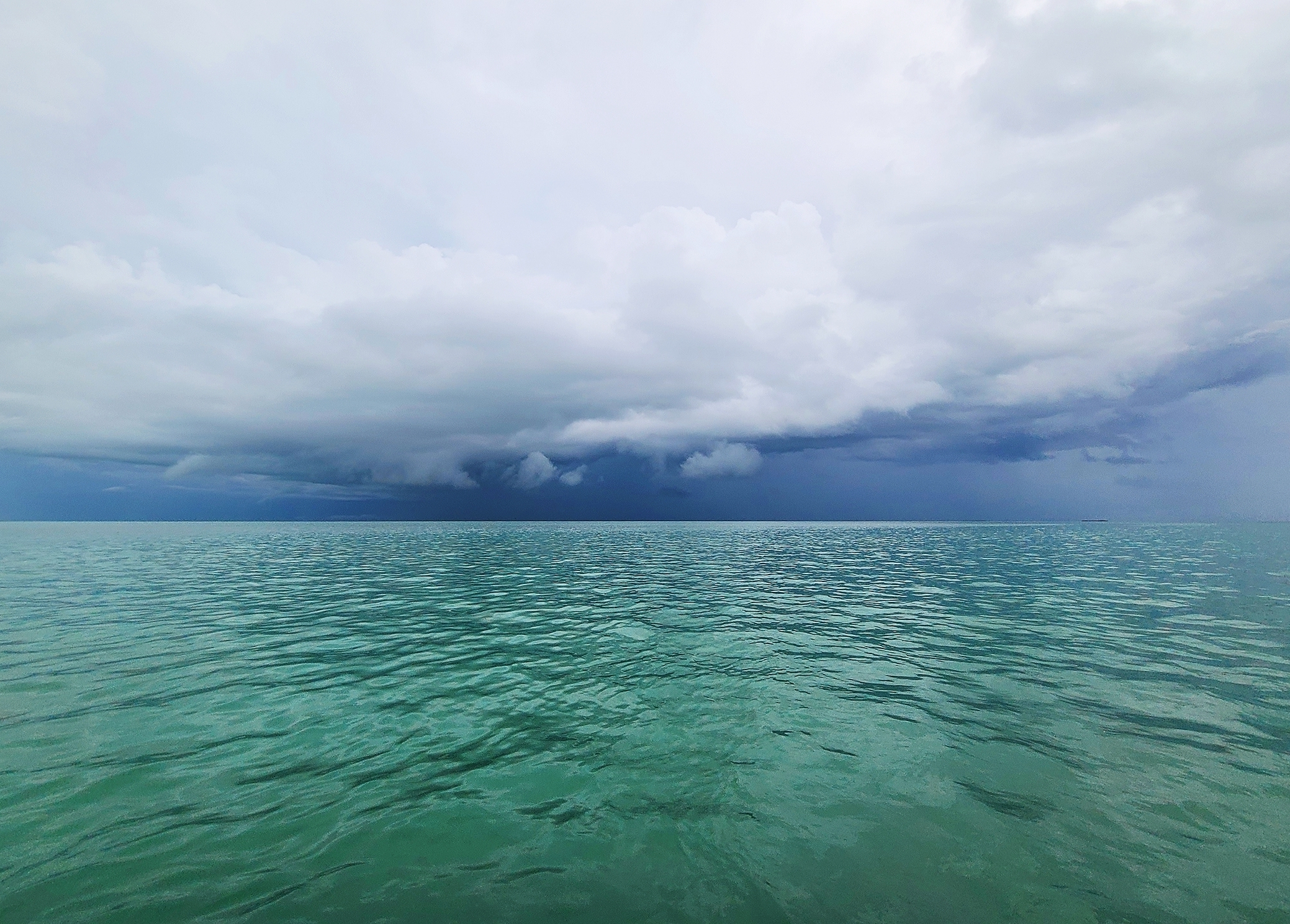 Chart of latest statistics from the Florida Keys Real Estate Market as of May 1, Photo of storm over the ocean